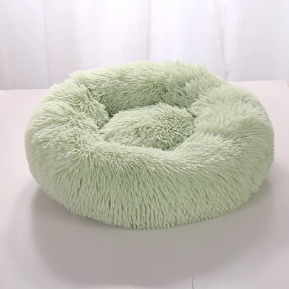 Lit Donut SnugNest, moelleux et confortable, en tissu fleece corail doux, disponible en plusieurs couleurs et tailles.