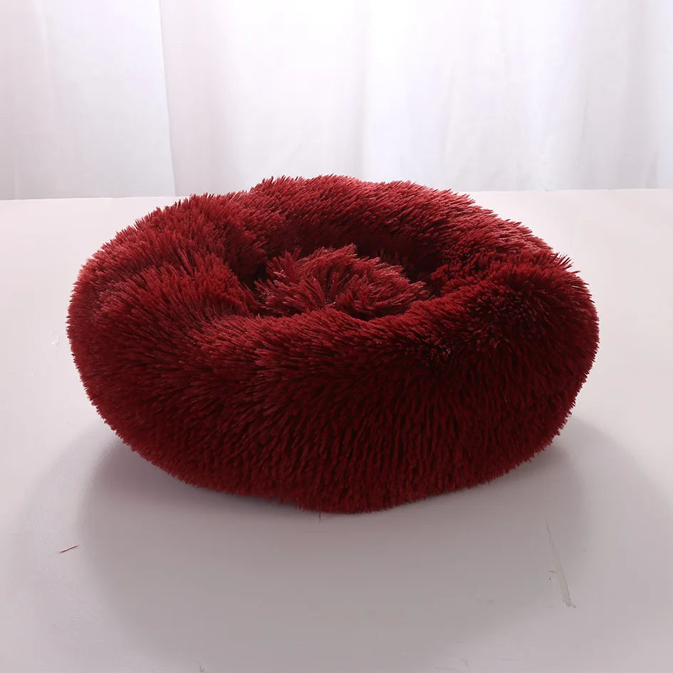 Lit Donut SnugNest, moelleux et confortable, en tissu fleece corail doux, disponible en plusieurs couleurs et tailles.