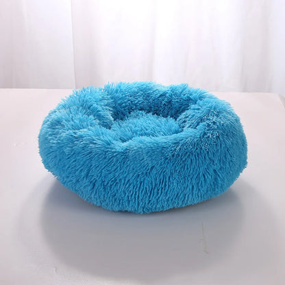 Lit Donut SnugNest, moelleux et confortable, en tissu fleece corail doux, disponible en plusieurs couleurs et tailles.